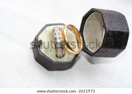 Heart shaped diamond ring and wedding band in antique leather box with copy space