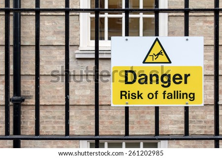 Caution Sign: Danger Risk of Falling on Metal Fence