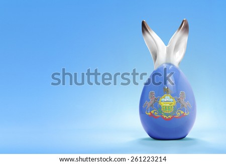 Colorful cute ceramic easter egg with rabbit ears and the flag of Pennsylvania .(series)