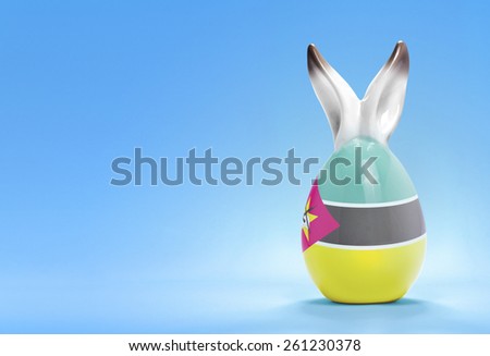 Colorful cute ceramic easter egg with rabbit ears and the flag of Mozambique .(series)