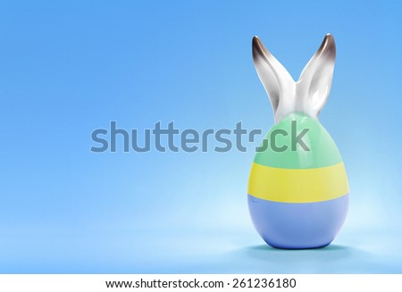 Colorful cute ceramic easter egg with rabbit ears and the flag of Gabon .(series)
