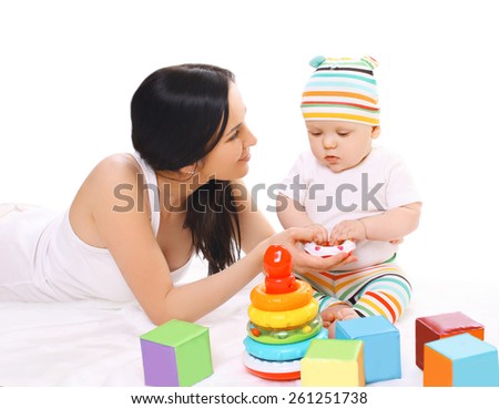 Young mother and baby playing with toys together
