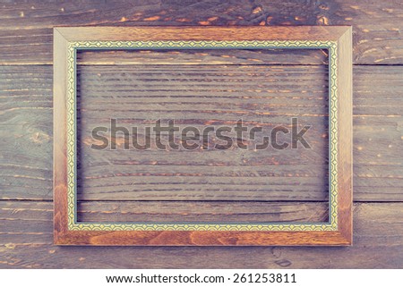 Photo frame on wooden background - vintage style effect picture