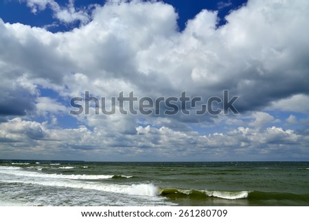 Cumulus clouds are flying on the Baltic sea