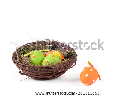 Easter Theme. Isolated on white. A nest with colorful Easter eggs.