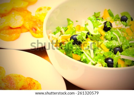 Assorted green leaf lettuce with squid and black olives, close up. instagram image retro style