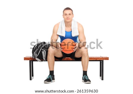 Male basketball player sitting on a bench isolated on white background