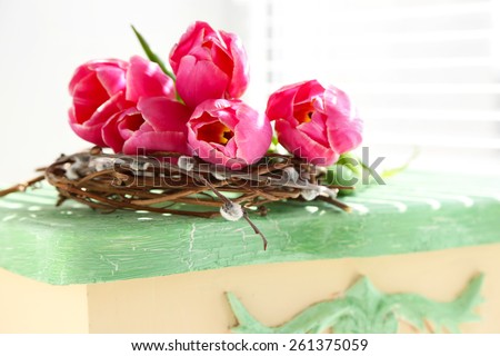 Pink beautiful tulips on green table with sunlight