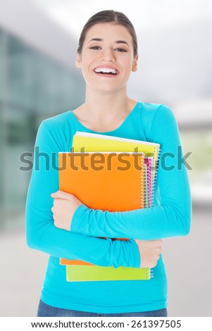 Beautiful young woman student with workbook