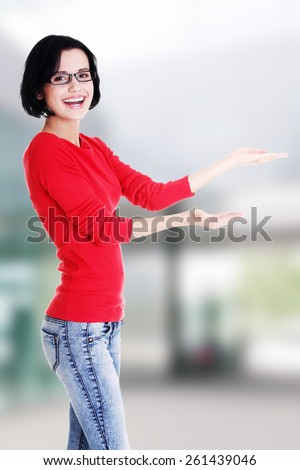 Happy , excited young woman pointing on copy space.