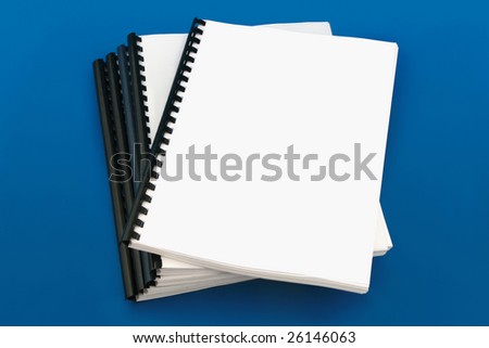 Spiral bound book, over blue background Royalty-Free Stock Photo #26146063