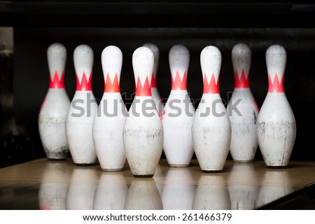 white with red stripe pins in of  triangle at bowling alley
