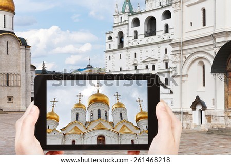 travel concept - tourist taking photo of Cathedral square in Moscow Kremlin on mobile gadget, Russia