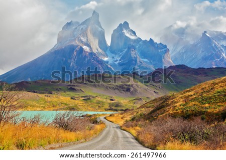 Summer day in the national park Torres del Paine, Patagonia, Chile. Majestic peaks of Los Kuernos over Lake Pehoe Royalty-Free Stock Photo #261497966