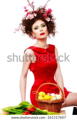 Easter Woman. Spring Girl with Fashion Hairstyle. Portrait of Beautiful Model with Colorful flowers