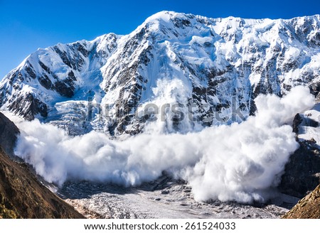 Power of nature. Real huge avalanche comes from a big mountain (Shkhara, 5,193 m), Caucasus, Kabardino-Balkaria, Bezengi region, Russia Royalty-Free Stock Photo #261524033