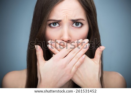 Woman covering mouth
 Royalty-Free Stock Photo #261531452
