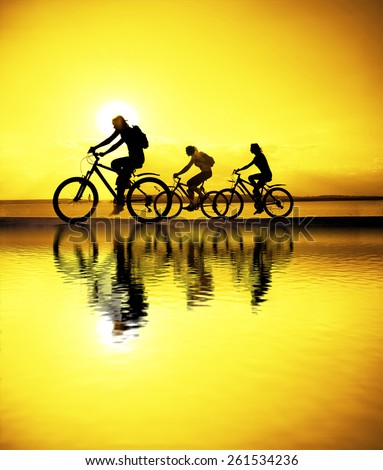 Image of sporty company friends on bicycles outdoors against sunset. Silhouette A lot phases of motion go of three 3 cyclist along shoreline coast Reflection sun on water Copy Space for inscription