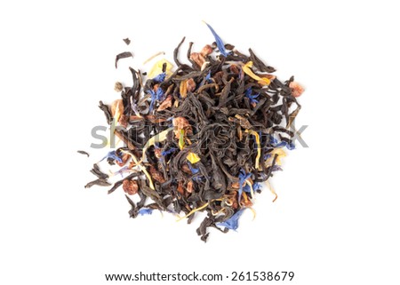 Small pile of big leaf black tea mixed with herbs and dry fruits. Calendula, sunflower, cornflower, rosehip berries. Top view, selective focus
