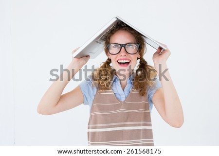 Geeky hipster woman covering her head with her laptop on white background