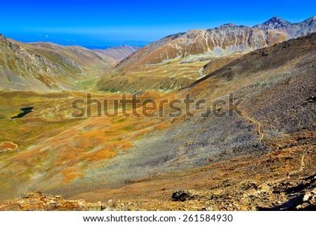 The trail in a mountain valley. Picture was taken during trekking hike in superior and scenic Caucasus mountains at autumn, Arhiz region, Abishira-Ahuba range, Karachay-Cherkessia, Russia
