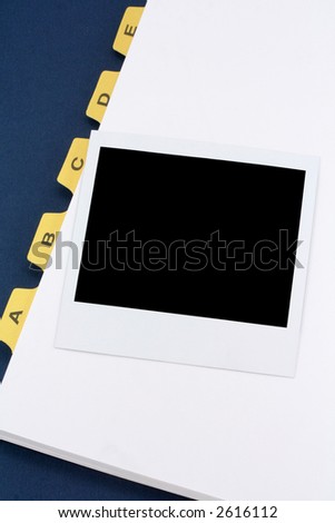 yellow file divider and photo, office supplies, close up