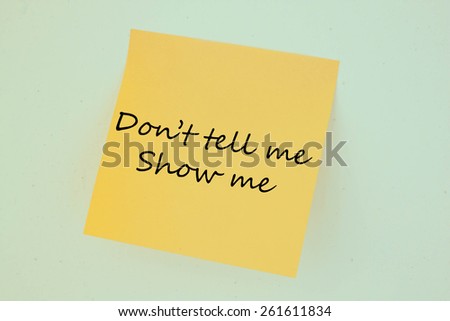 Text don't tell me show me on the short note texture background