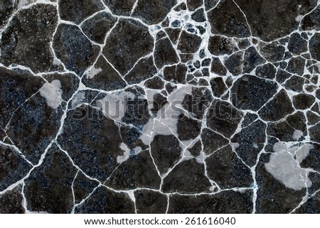black wall with white cracks