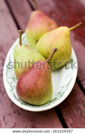 Ripe sweet pear lying on a white plate