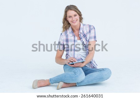 Pretty hipster using tablet on white background