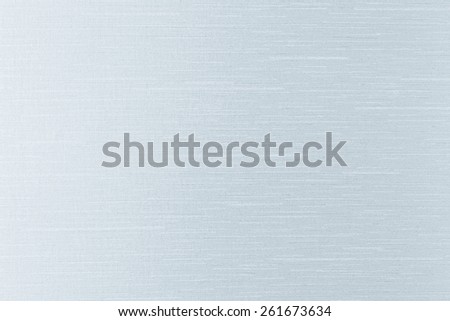 Silk shiny metallic fabric texture background in light silver blue color 