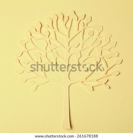 Beautiful handmade paper tree silhouette on paper background, square toned image
