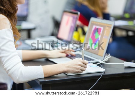 Woman hand drawing with graphics tablet, working designer