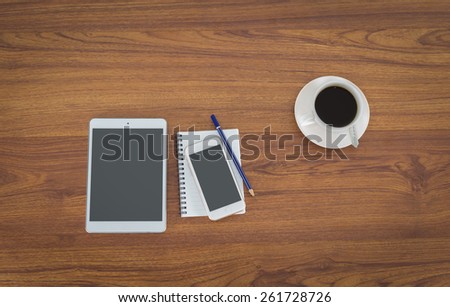 Office table with notepad, coffee cup , pencil,smartphone,tablet View from above with copy space