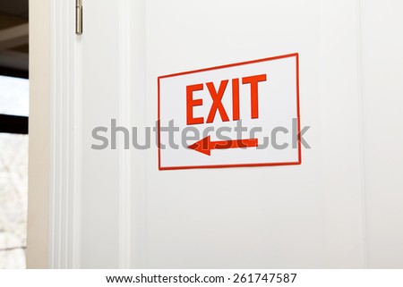 Arrow exit hanging on door specifying the path