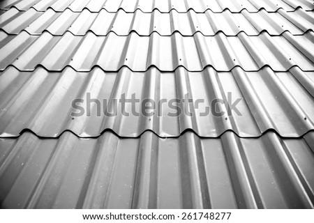Gray tile roof floor background. Closeup roofing texture pattern. Materials to build a house for sun and rain protection. White backdrop with top rays light. Royalty-Free Stock Photo #261748277