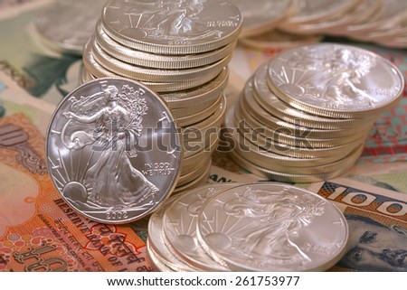 Pile of money and stacked coins international for business and finance sterling silver walking liberty