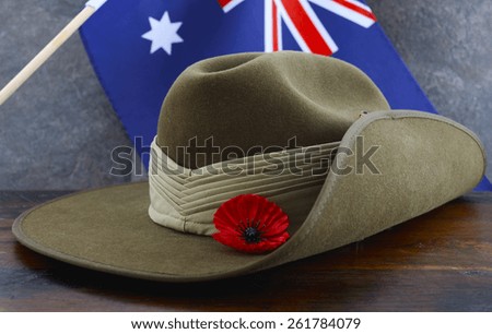 Anzac army slouch hat with Australian Flag on vintage wood background. Royalty-Free Stock Photo #261784079