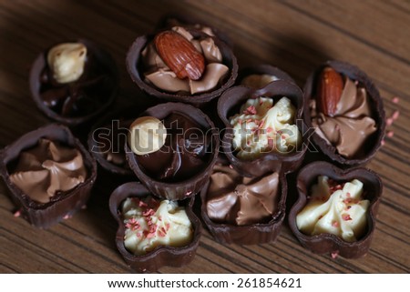 An assortment of fine chocolates on wooden background