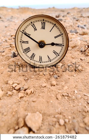 Classic Analog Clock In The Sand On The Rock Desert