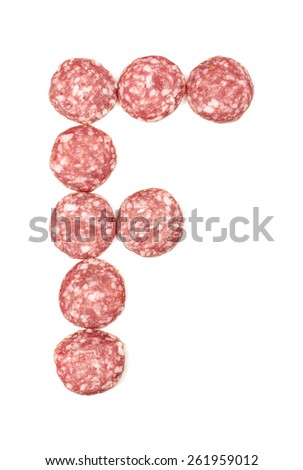Alphabet letter F arranged from salami sausage slices isolated on the white