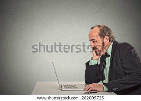 Man working reading something on his laptop computer 