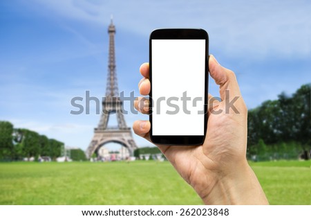 takin a photograph of the eiffel tower in paris with one smartphone