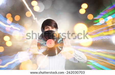 Young handsome man with disco plate in hands