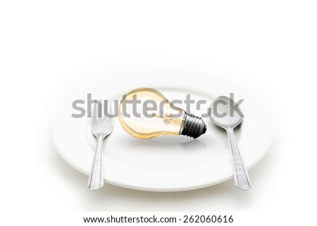 Light bulb in plate and fork and spoon isolated on white. brain food  Idea concept