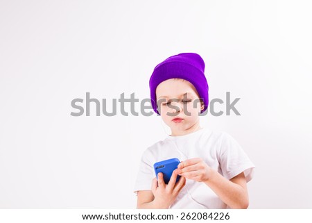 Little boy listens to music with a smartphone