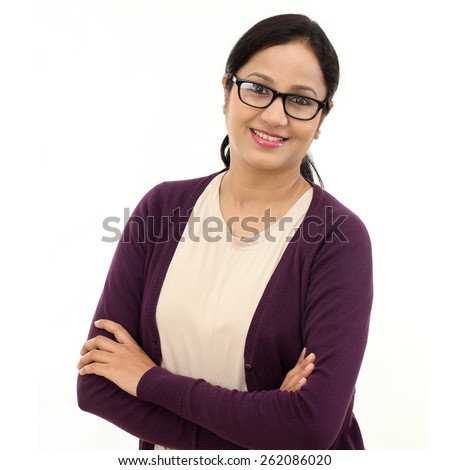 Happy young woman with arms crossed against white Royalty-Free Stock Photo #262086020