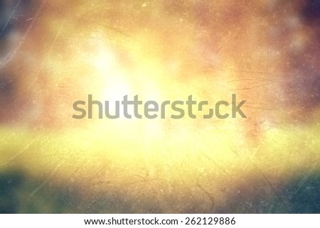 abstract photo of light burst among trees and glitter bokeh lights. image is blurred and filtered .
