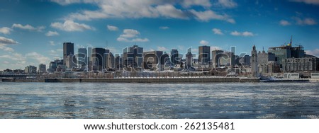 Montreal by a very cold day.  St-Lawrence river with ice with downtown Montreal in background 