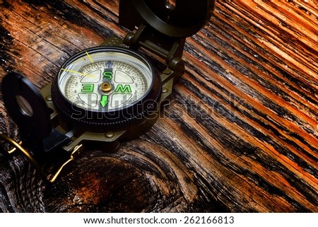 compass on wooden surface and steam
